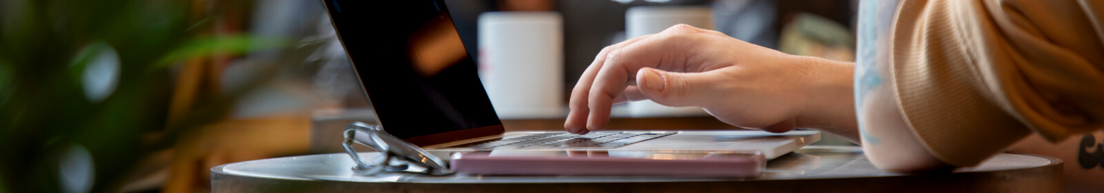 hands typing on a laptop keyboard